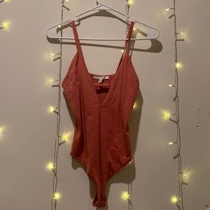 Express small v neck body suit with thong bottom.